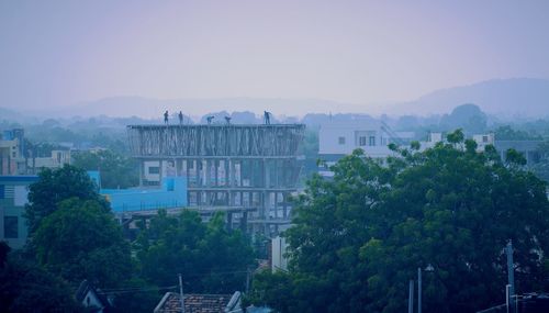 High angle view of trees and buildings in city