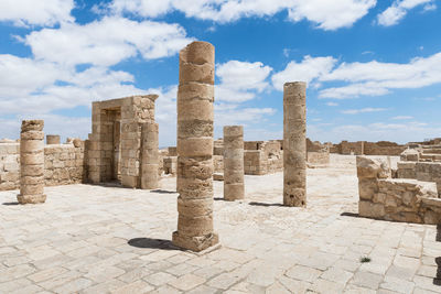 Ruins of historical building against cloudy sky