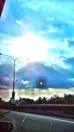 Country road against cloudy sky
