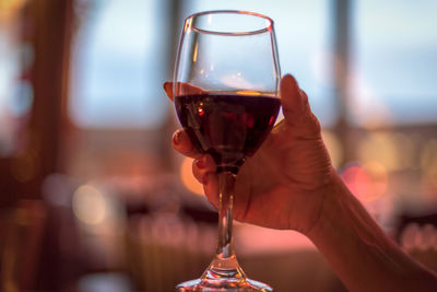 Close-up of hand holding glass of wine