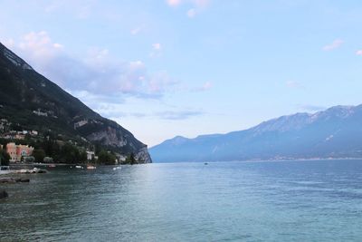 Scenic view of sea and mountains against sky