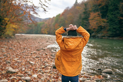 Rear view of man standing in park during autumn