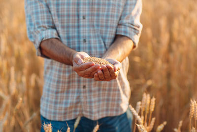 Midsection of man standing in field