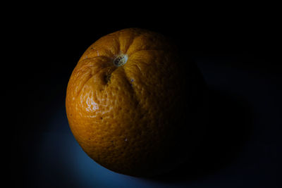 Close-up of orange over black background