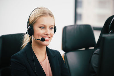 Close-up of call center employee with headset at office