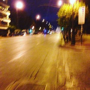 Illuminated city street at night