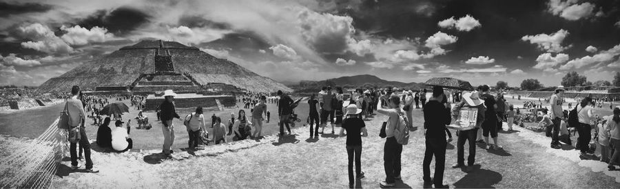 Panoramic view of people in row against sky