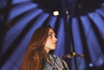 Low angle view of young woman looking away