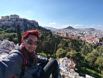 Portrait of young man with sunglasses on mountain