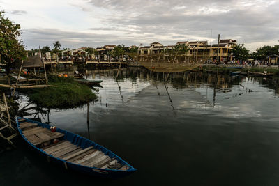 View of buildings in town against cloudy sky