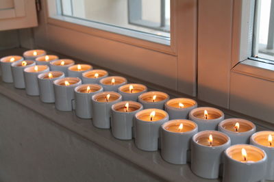 Row of illuminated candles