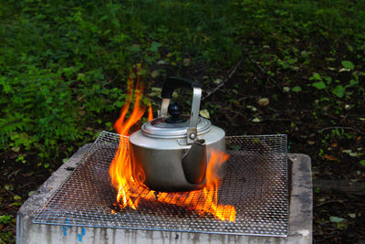Close-up of kettle over fire pit