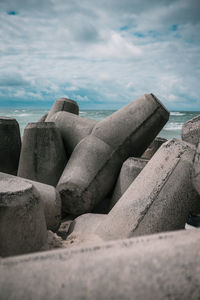 Rocks on beach against sky