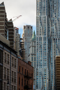 Low angle view of buildings in city against sky