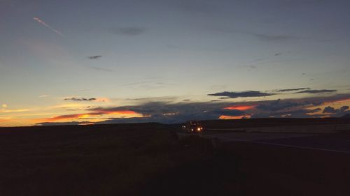 Cars on road at sunset