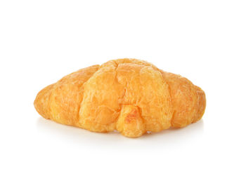 Close-up of bread in plate against white background