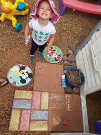 Girl playing with multi colored umbrellas