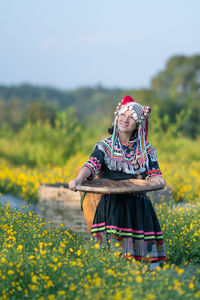 Low angle view of woman standing on field