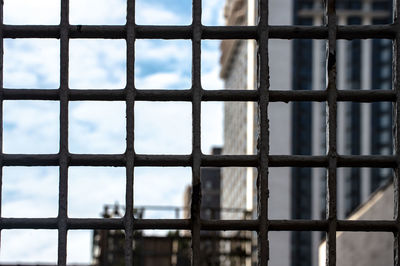 Full frame shot of metal fence against sky