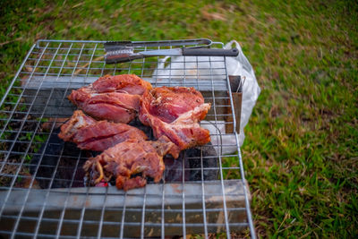 High angle view of meat on barbecue grill