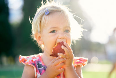 Portrait of cute girl eating food