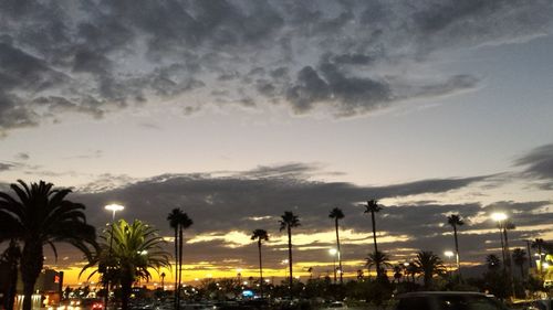 Traffic on road against sky at dusk