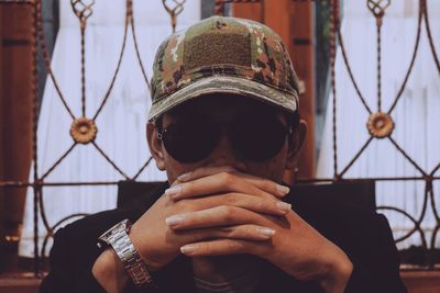 Close-up of mid adult man wearing cap and sunglasses