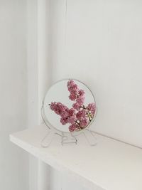 Close-up of flowers reflecting in mirror