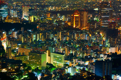 High angle view of illuminated buildings in city at night