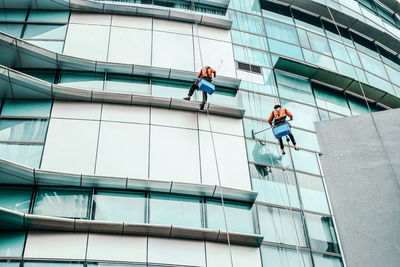 Low angle view of man working on building