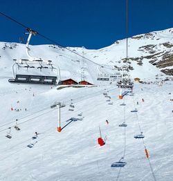 Aerial view of ski lift over mountains against sky