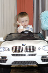 Boy in car at home