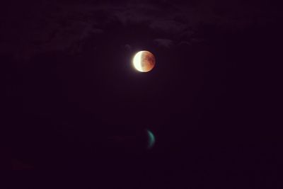 Low angle view of moon against sky at night