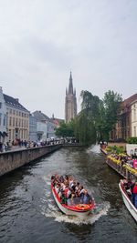 Boats in river with buildings in background