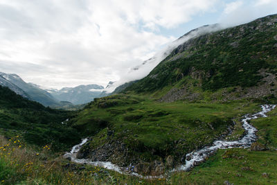 Scenic view of mountains against cloudy sky