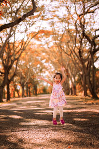 Full length of girl walking on road