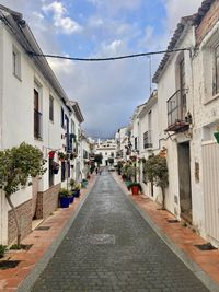 Footpath amidst buildings in old city center of estepona, malaga - spain 
