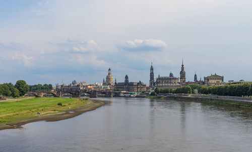 River amidst buildings against sky in city