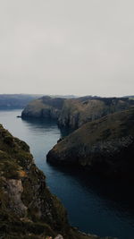 Scenic view of sea and cliff against sky