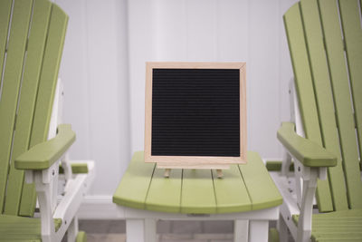 Empty chairs and table against wall at home