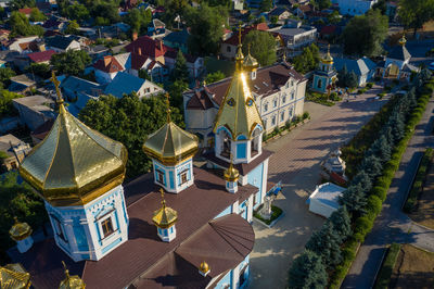 High angle view of houses by trees in town