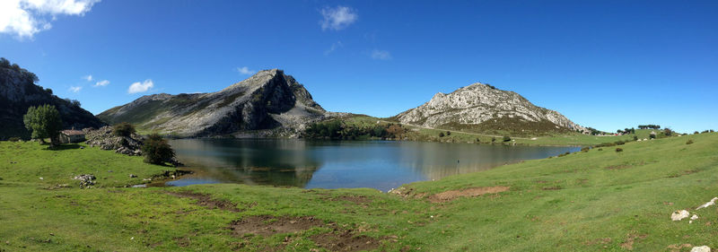 Panoramic view of lake and mountains against blue sky