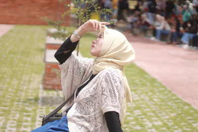 Side view of woman standing outdoors