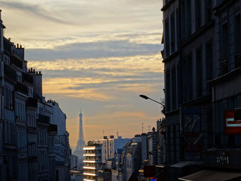 Buildings in city at sunset
