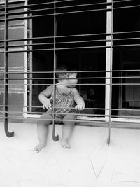 Full length of boy sitting outdoors