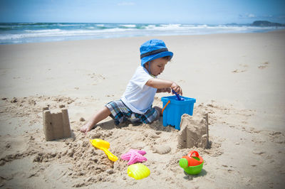 Boy playing with toys on beach