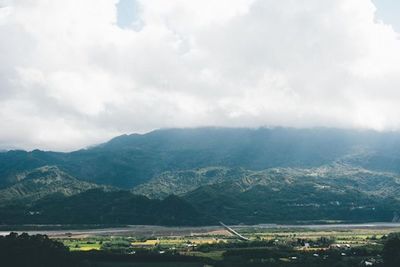 Scenic view of mountains against cloudy sky