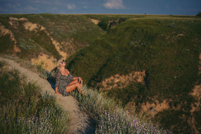 Rear view of woman standing on mountain