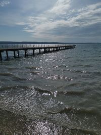 Pier over sea against sky