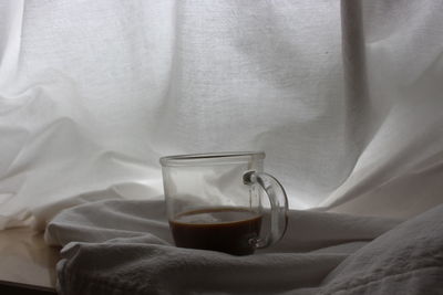 Close-up of drinking glasses on bed
